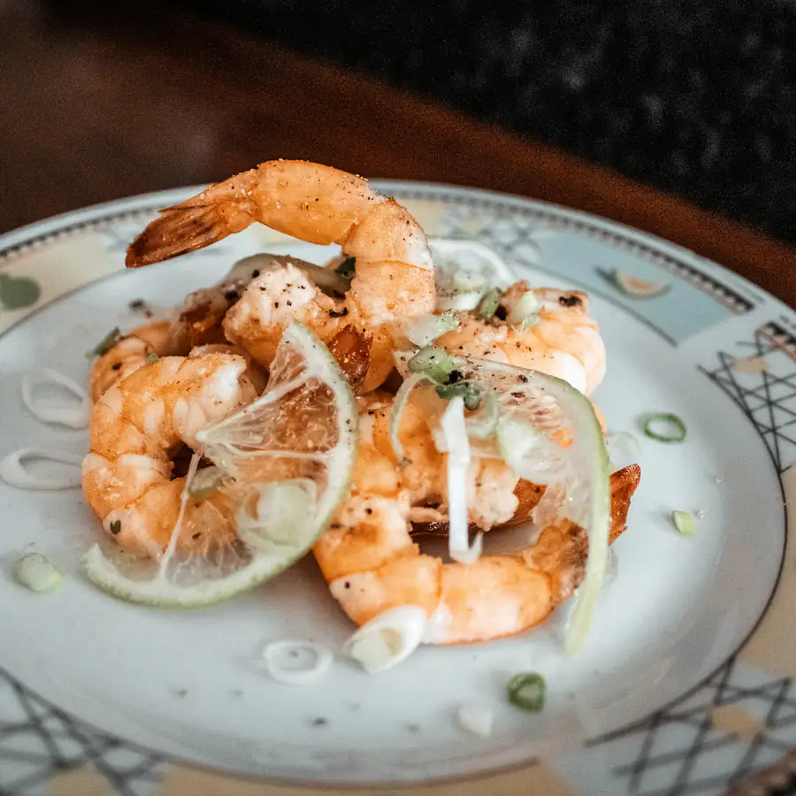 Garlic butter prawns with rice in a pan